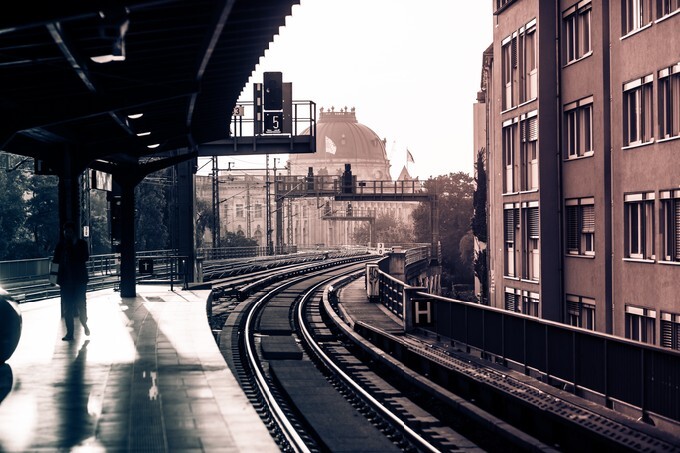 Vintage train station with railway lines in Berlin. Retro filtered. Monochrome cream tone. Black and white photography.